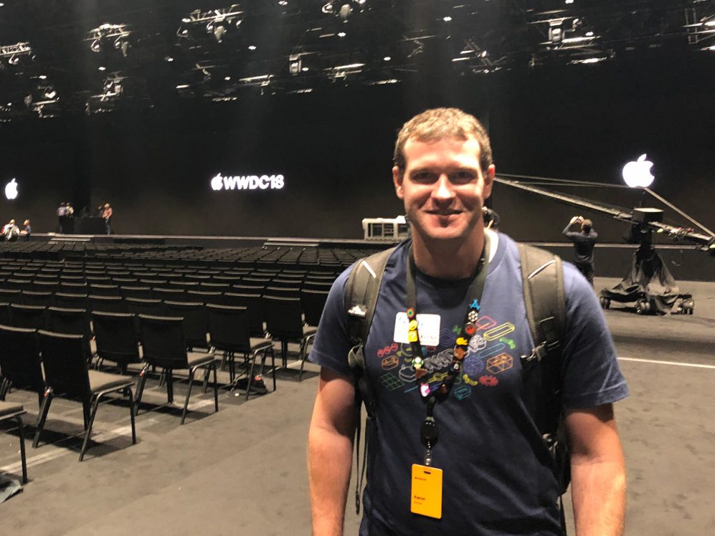 Aaron standing in front of a Apple sign at WWDC 2018